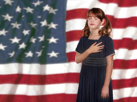 Child pledging allegiance to US Flag Child saying the pledge of Allegiance to United States