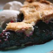Slice of blueberry pie with ice cream