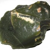 Deep green nephrite jade from Wyoming; chipped and possibly a native American artifact